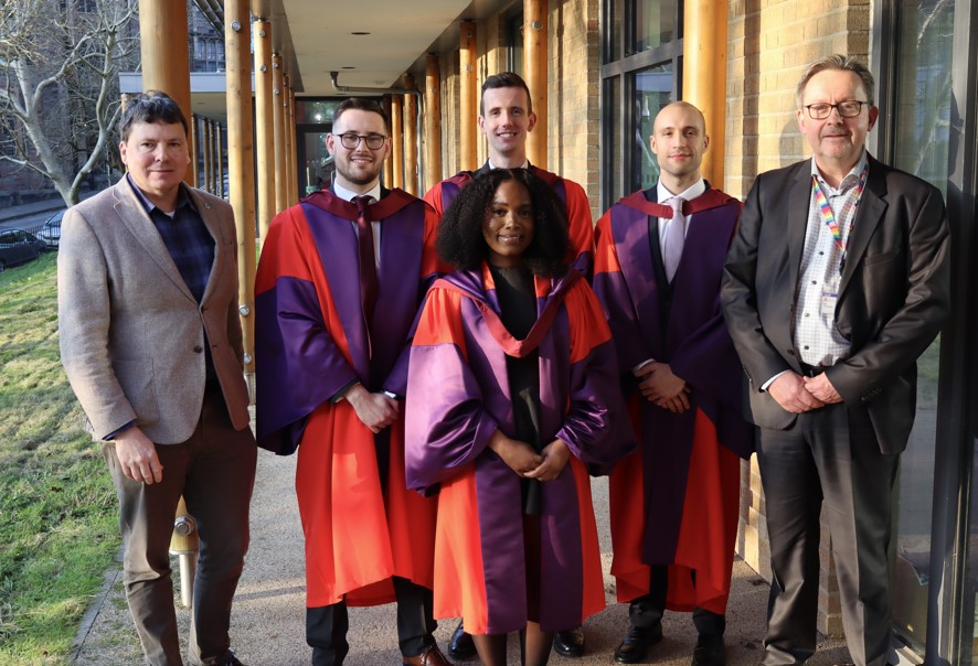 Four graduates and the BCI Co-directors